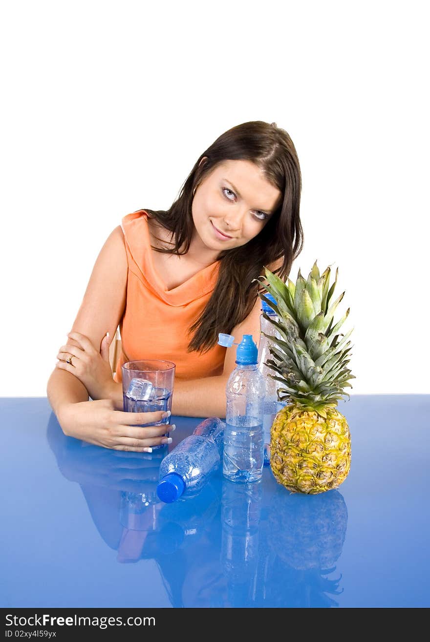 Beautiful young girl sitting in a blue desk. Accompanied by fruit girl