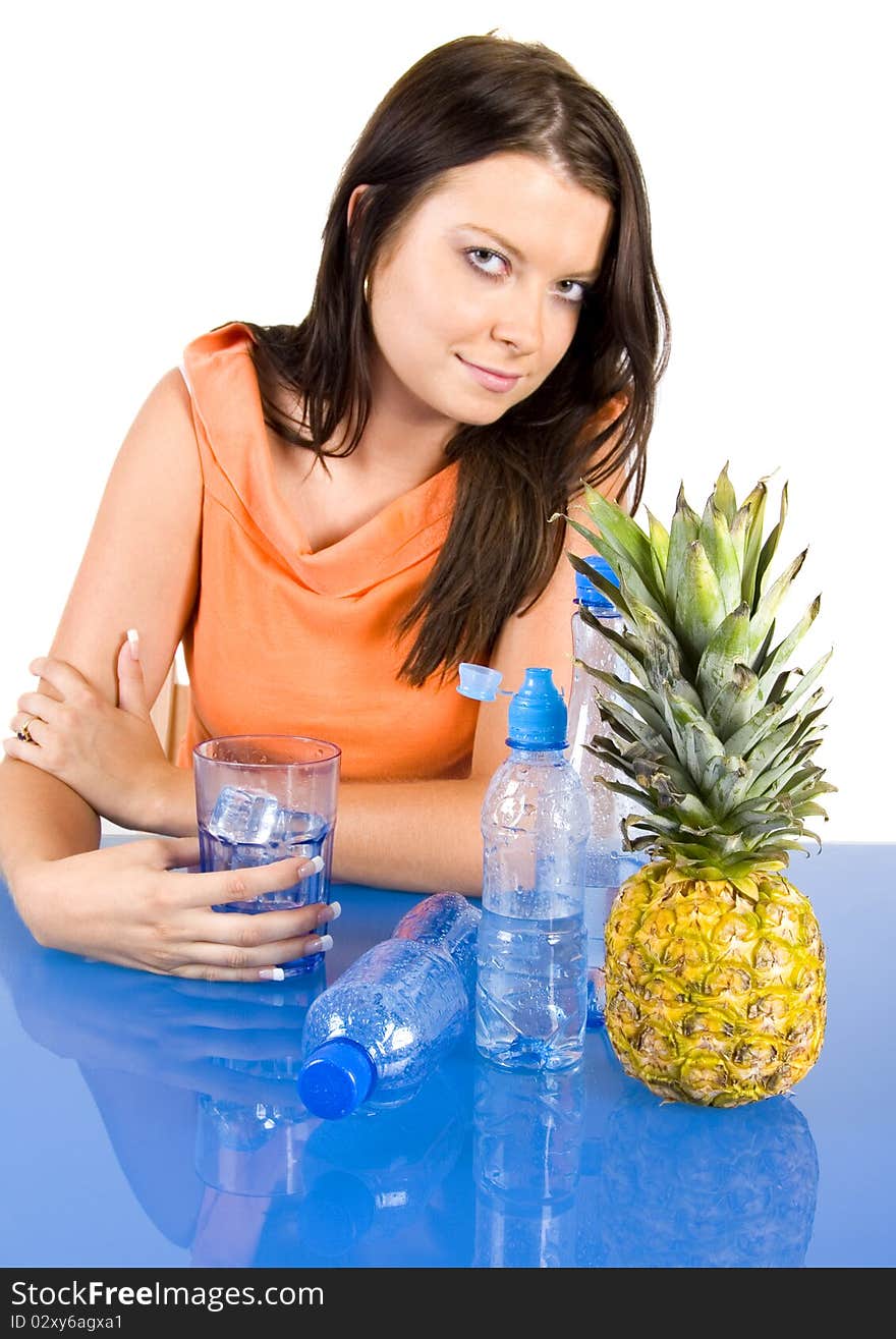 Beautiful young girl sitting in a blue desk. Accompanied by fruit and water girl. Beautiful young girl sitting in a blue desk. Accompanied by fruit and water girl.