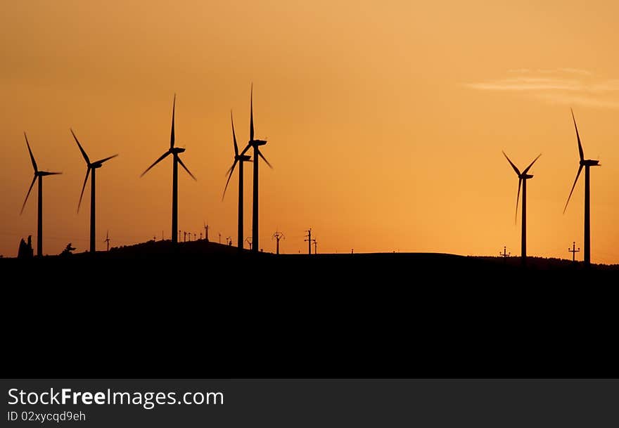 Wind turbines at sunset (silhouette)