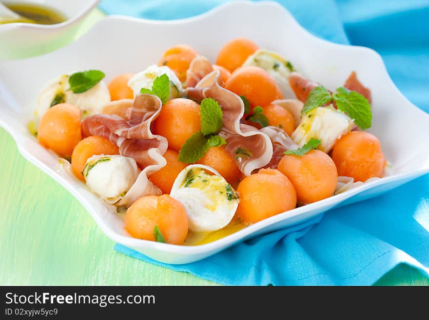 Melon,mozzarella,ham salad with mint vinaigrette. Melon,mozzarella,ham salad with mint vinaigrette