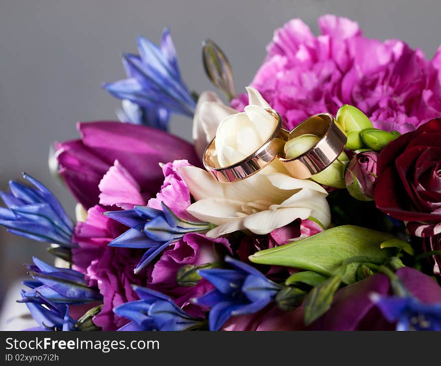 Closeup of wedding rings on a bouquet