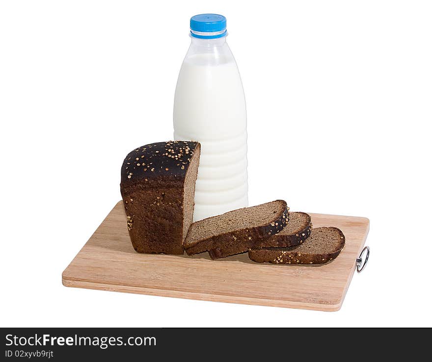 Bottle of milk and rye bread on a board