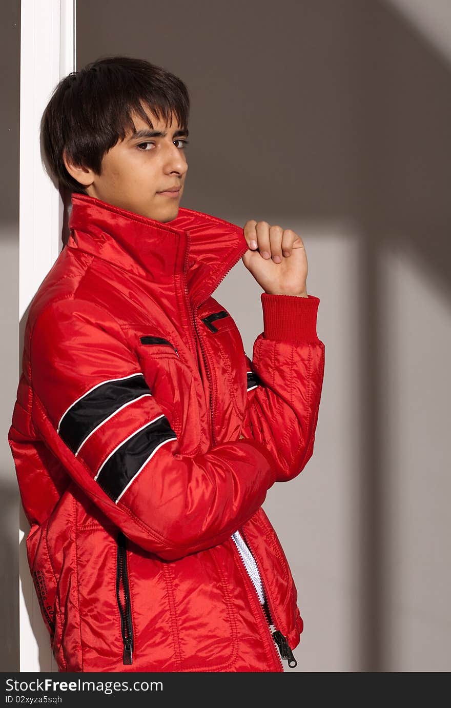 Portrait of a handsome young man of sixteen. Youth shows autumn, winter clothing. Portrait of a handsome young man of sixteen. Youth shows autumn, winter clothing.