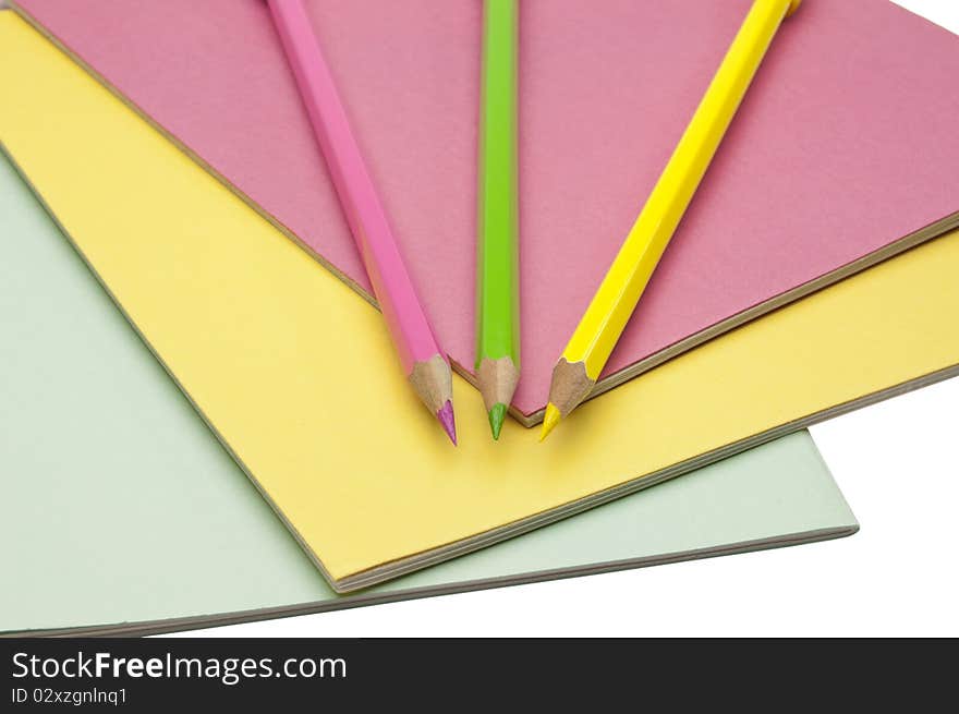 Notebooks and pencils isolated on white background