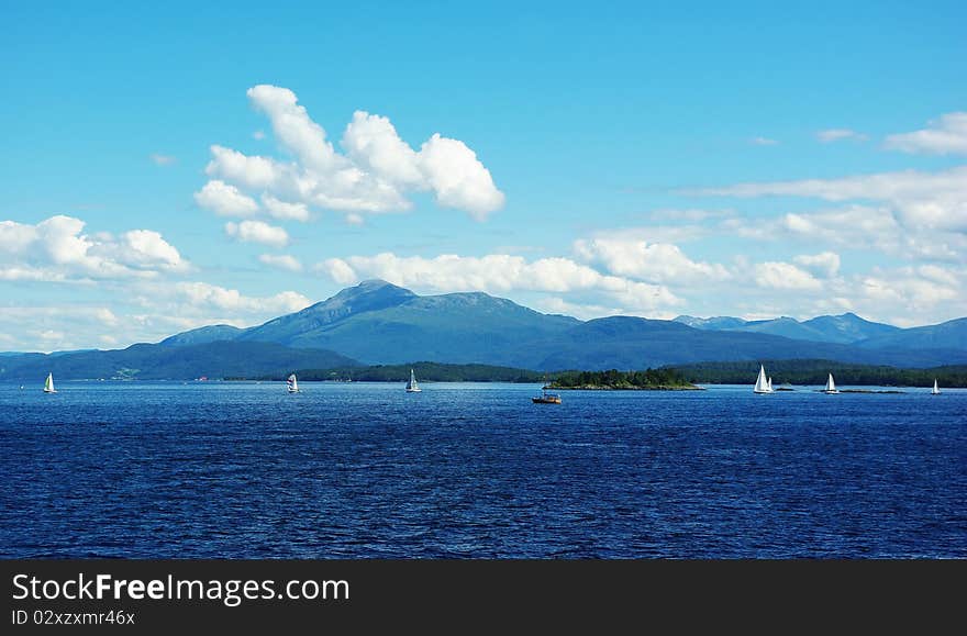 Beautiful view of the Norwegian coast of northern Atlantic with yachts and sailboats. Beautiful view of the Norwegian coast of northern Atlantic with yachts and sailboats