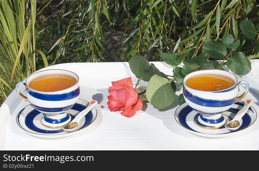 Two porcelain cups with tea