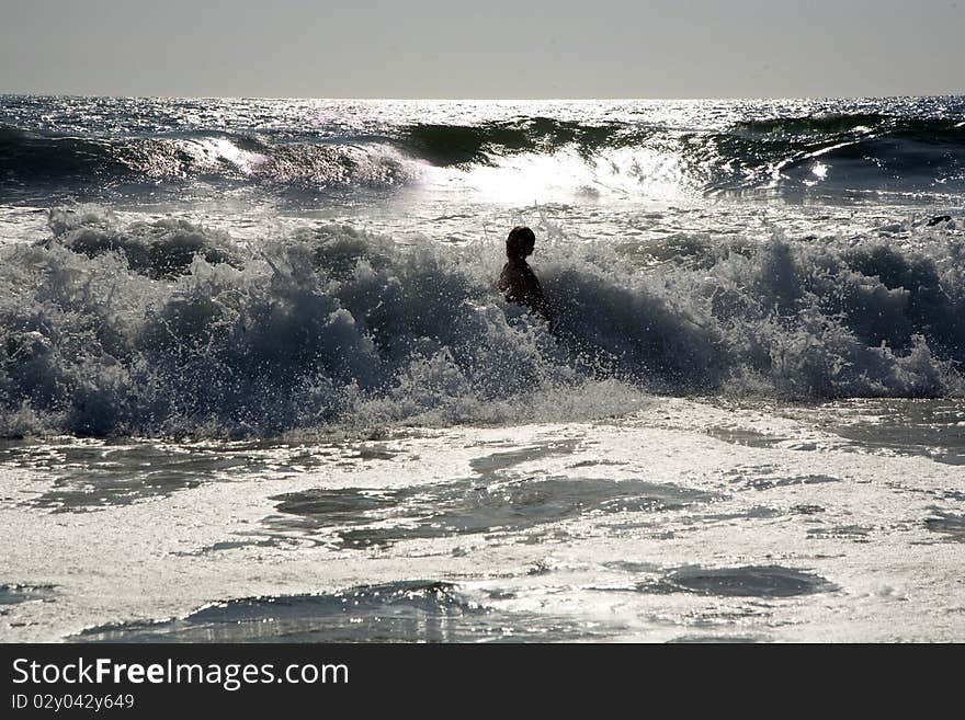 Swimmer in silver light at sunset