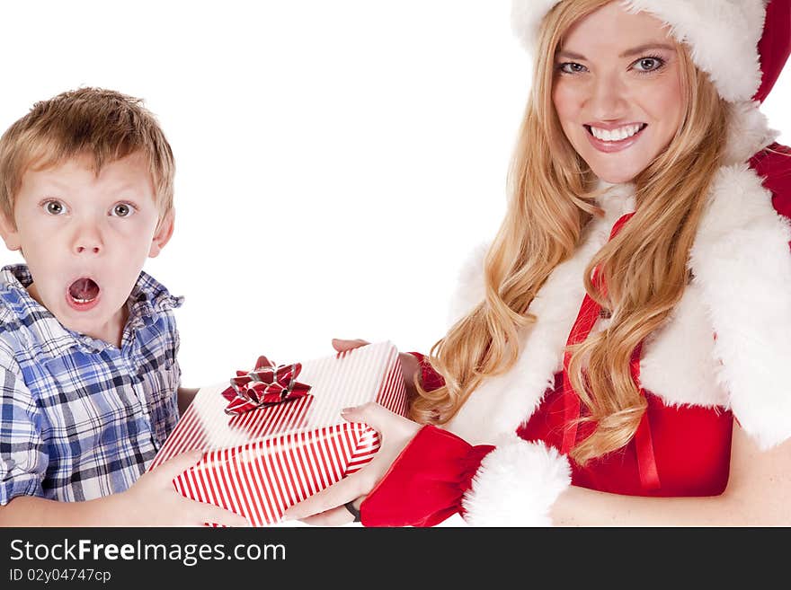 Mrs Santa is giving a surprised young boy a gift. Mrs Santa is giving a surprised young boy a gift.