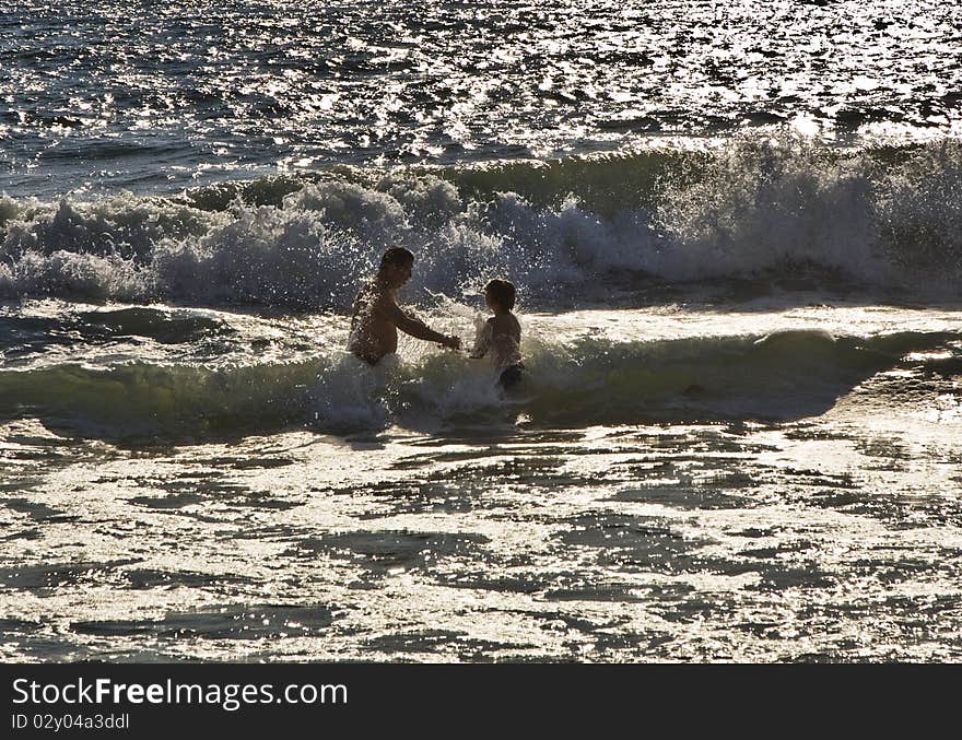 Bathing in sunset in waves at  the beach of Redondo, California