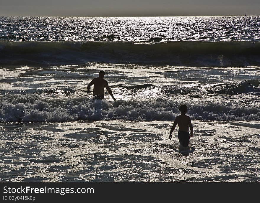 Bathing in sunset in waves at the beach of Redondo, California. Bathing in sunset in waves at the beach of Redondo, California