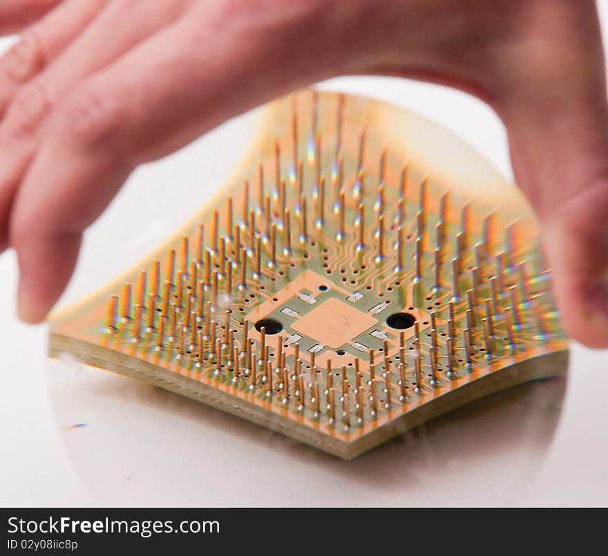 CPU under the magnifying glass in the human hand