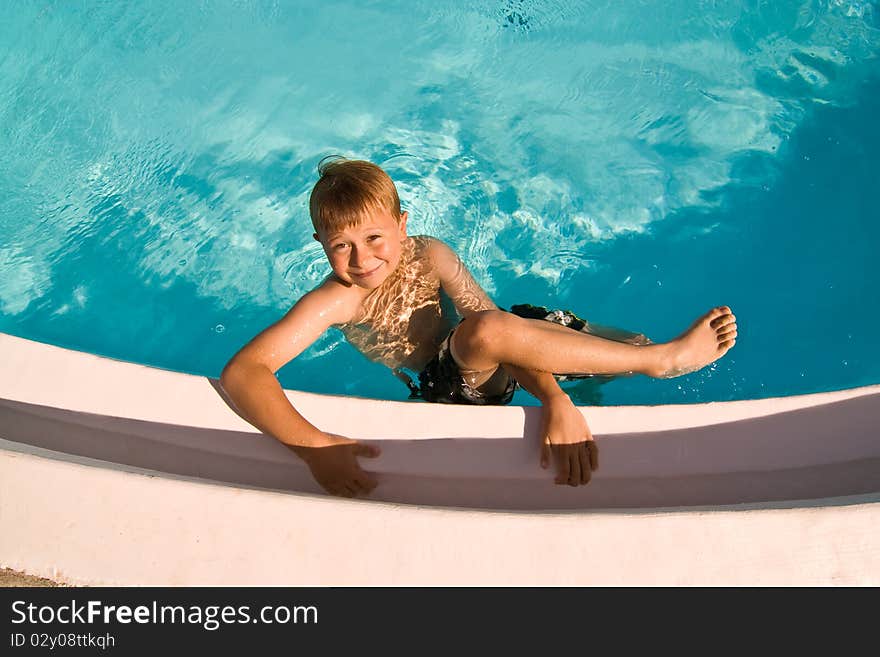 Child is posing in the pool