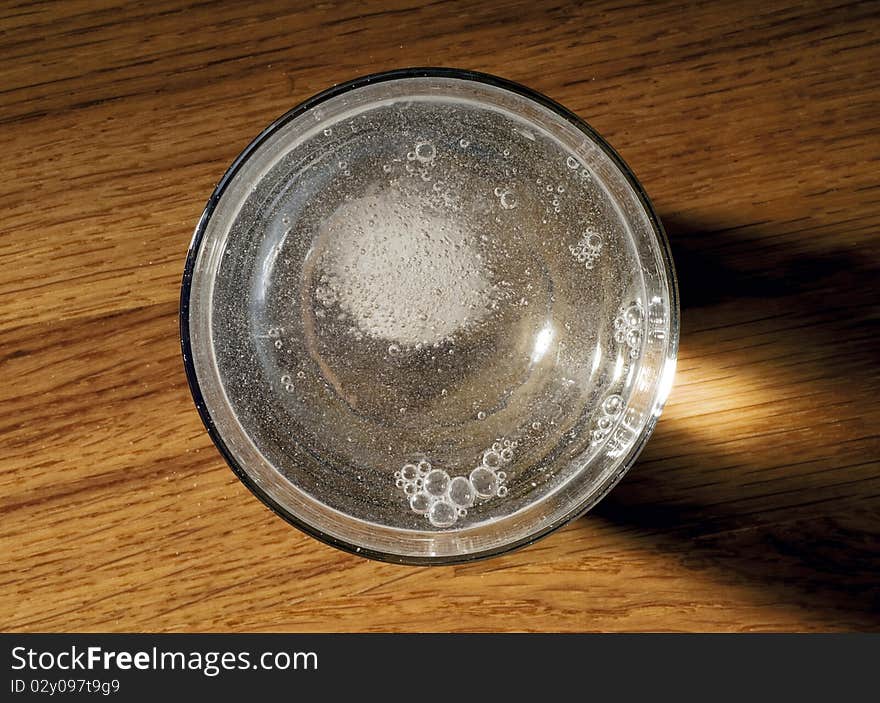 Medicine in a glass of sparkling water