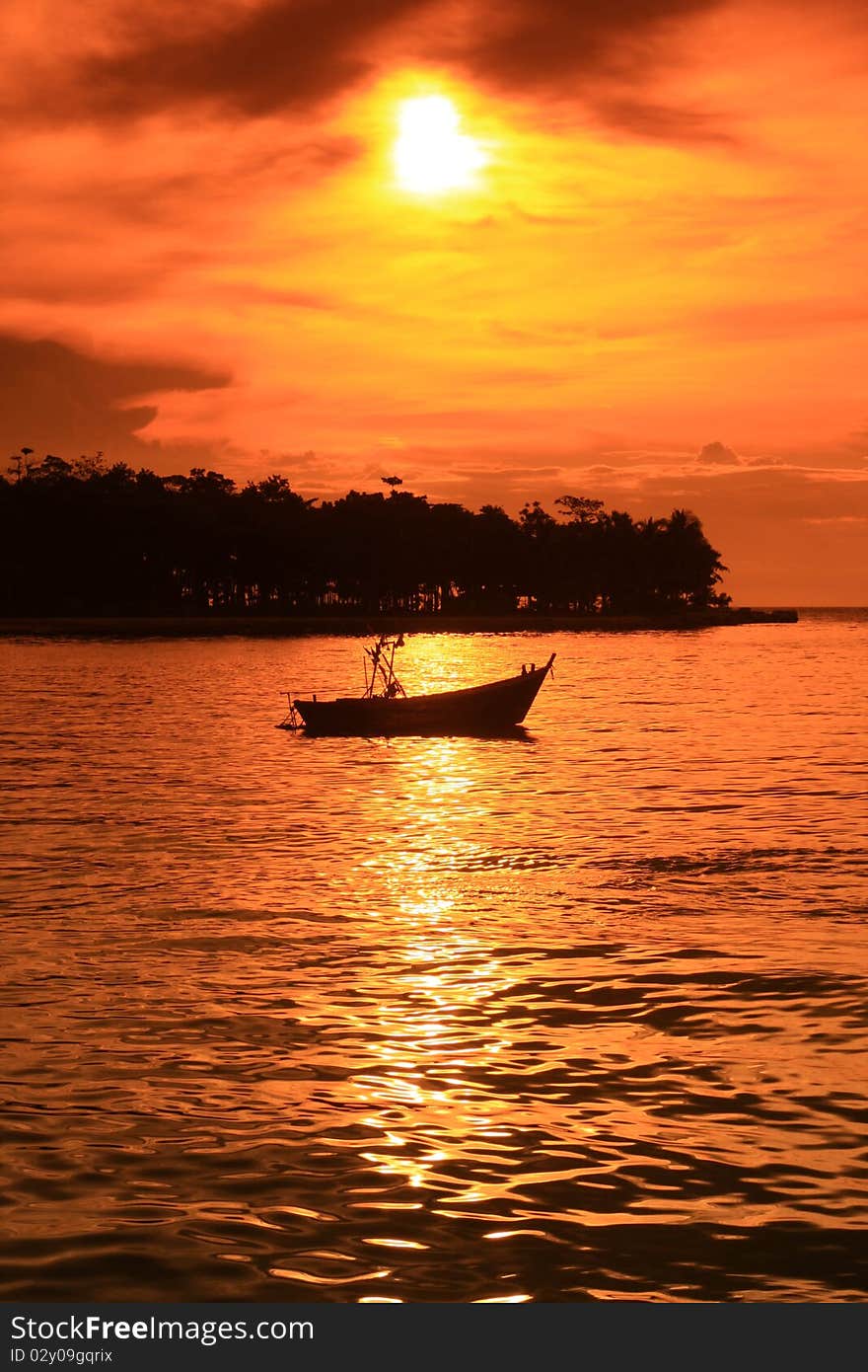 Slow boat and sunset on the beach