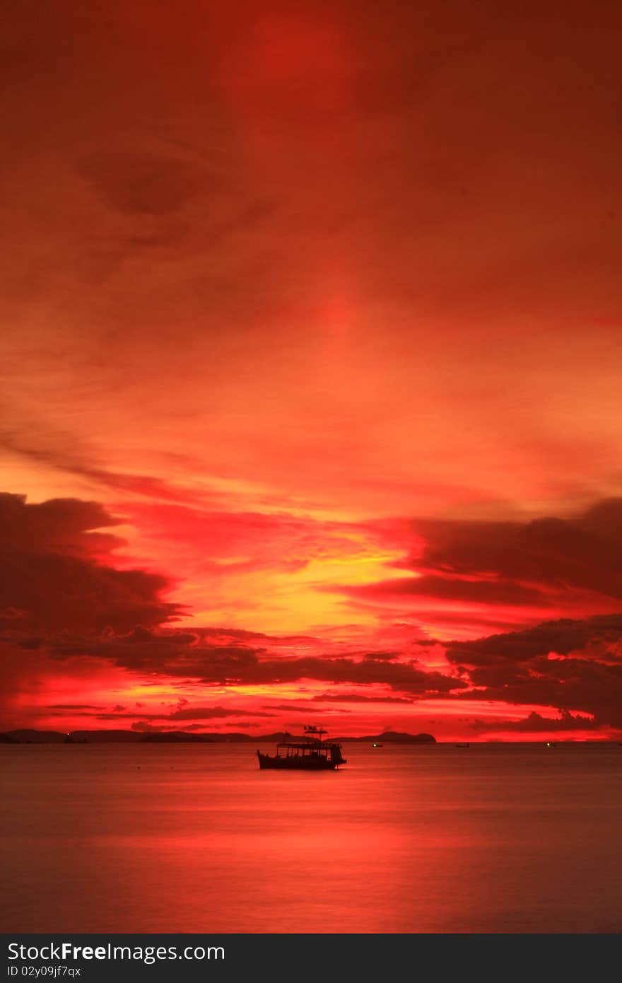 Slow boat and sunset on the beach