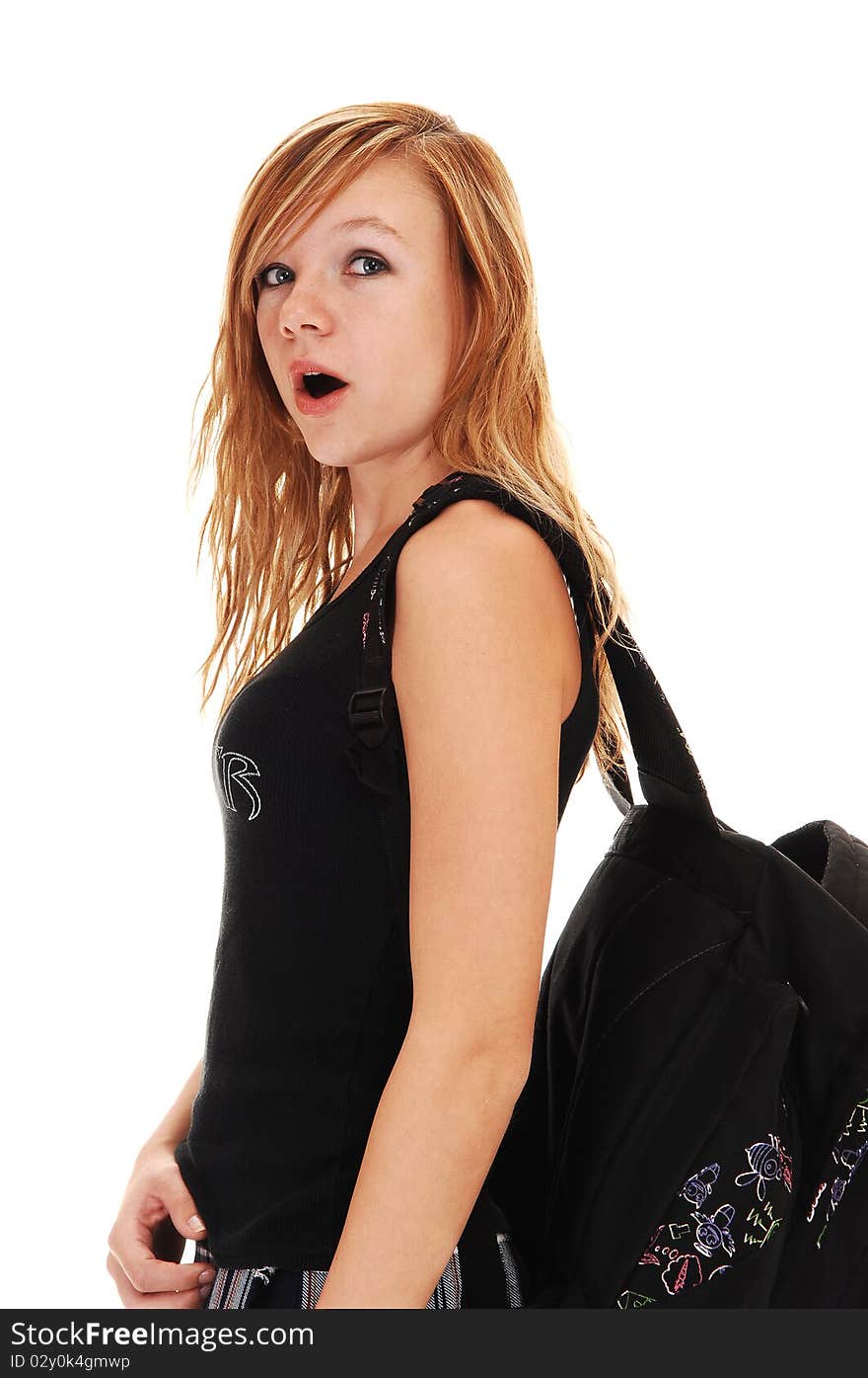 A young teenager with her back bag over her shoulder on the way to school, on white background. A young teenager with her back bag over her shoulder on the way to school, on white background.