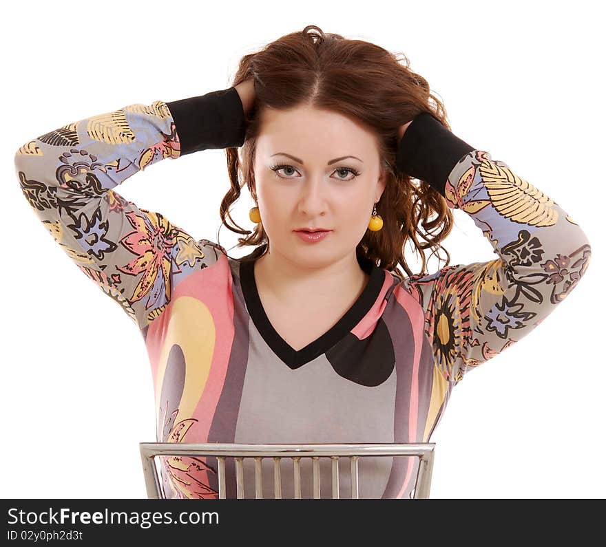 Beautiful girl with curly hair sits on chair