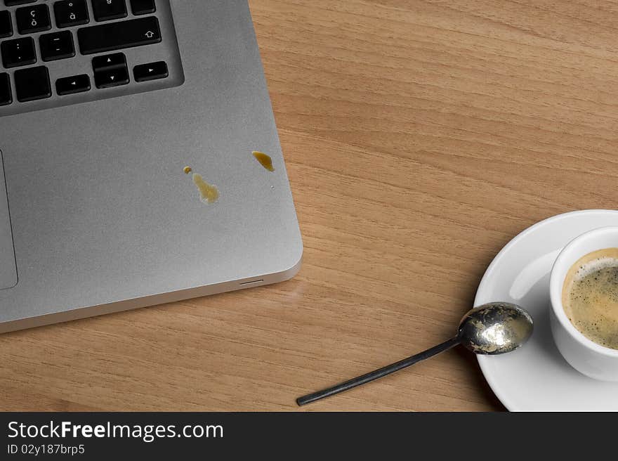 Coffee cup and laptop on the table