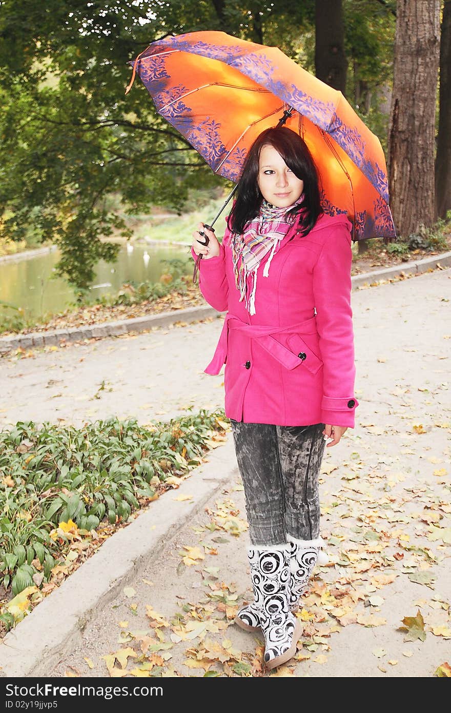 Girl in the autumnal park with the umbrella. Girl in the autumnal park with the umbrella