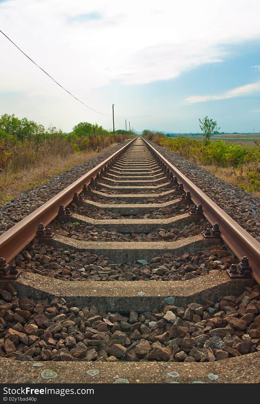 Photo of an out of use part of rail tracks running into the distance in Vojvodina, Serbia, near Belgrade. Photo of an out of use part of rail tracks running into the distance in Vojvodina, Serbia, near Belgrade