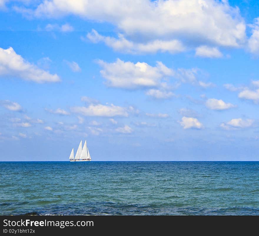 boat with white sails at sea. boat with white sails at sea