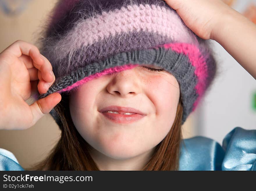 Portrait of funny smiling girl in a hat indoors. Portrait of funny smiling girl in a hat indoors