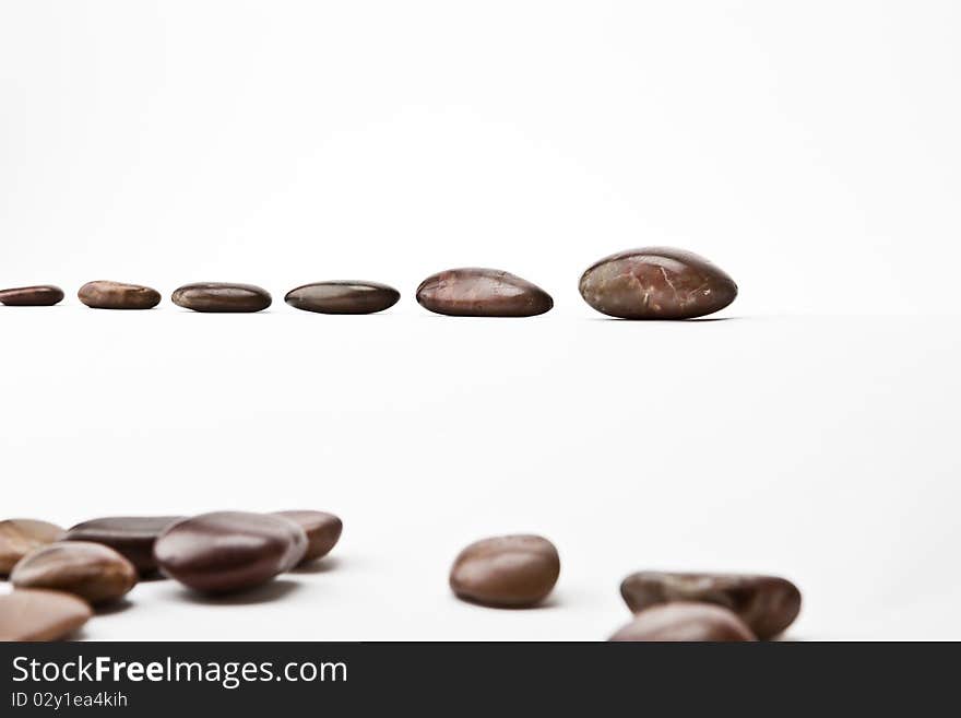 A shot of river pebbles in a strait formation.