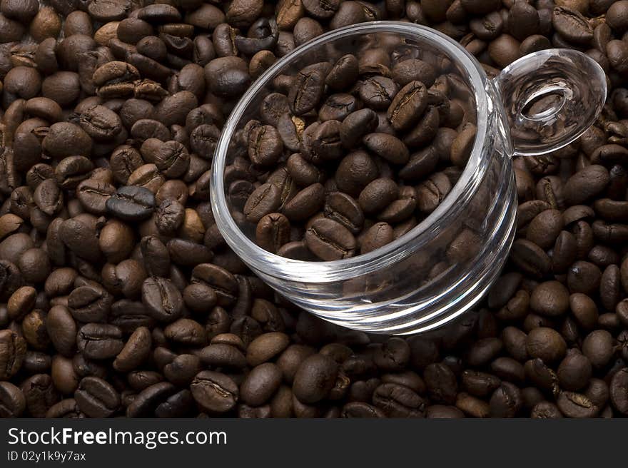 Topview of a glass coffee cup filled with coffee beans