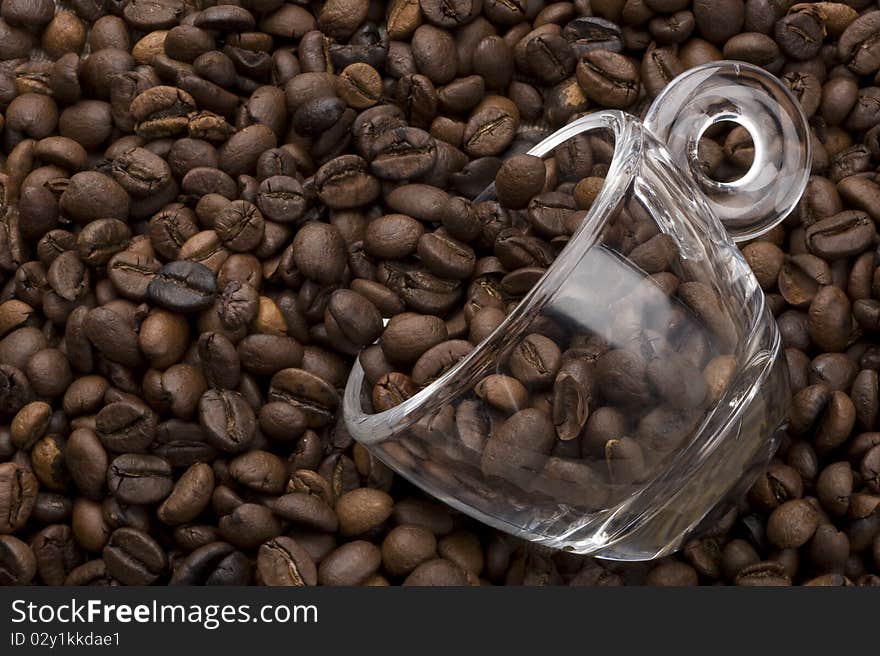 Topview of a glass coffee cup filled with coffee beans