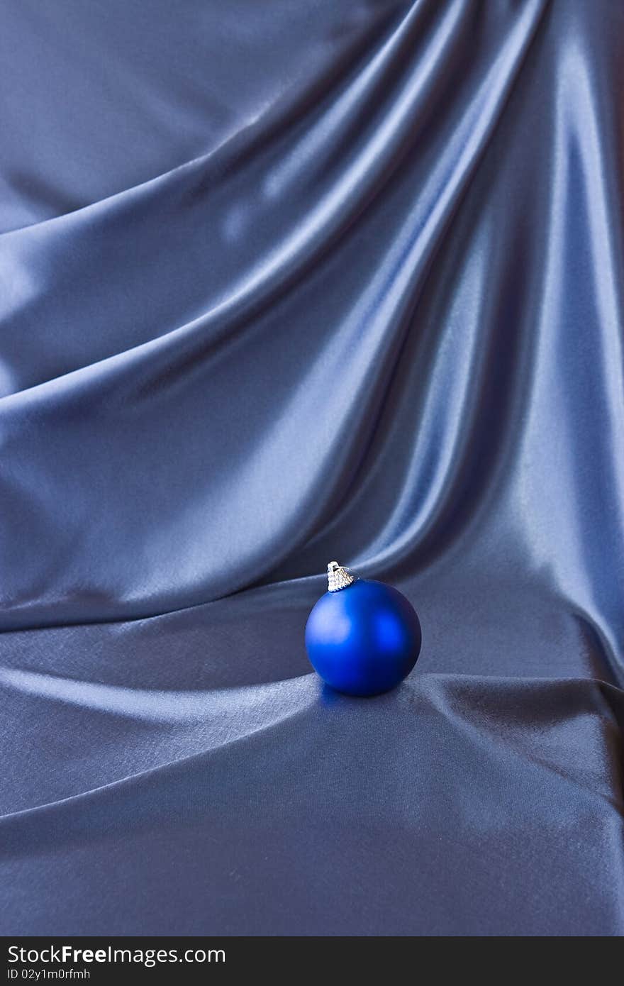 Satin background with Christmas decorations; place for your object. Satin background with Christmas decorations; place for your object