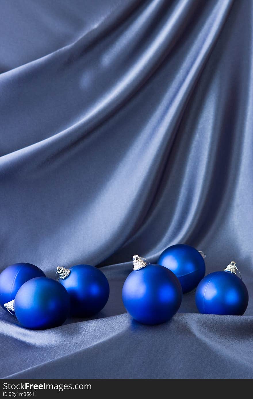 Satin background with Christmas decorations; place for your object. Satin background with Christmas decorations; place for your object