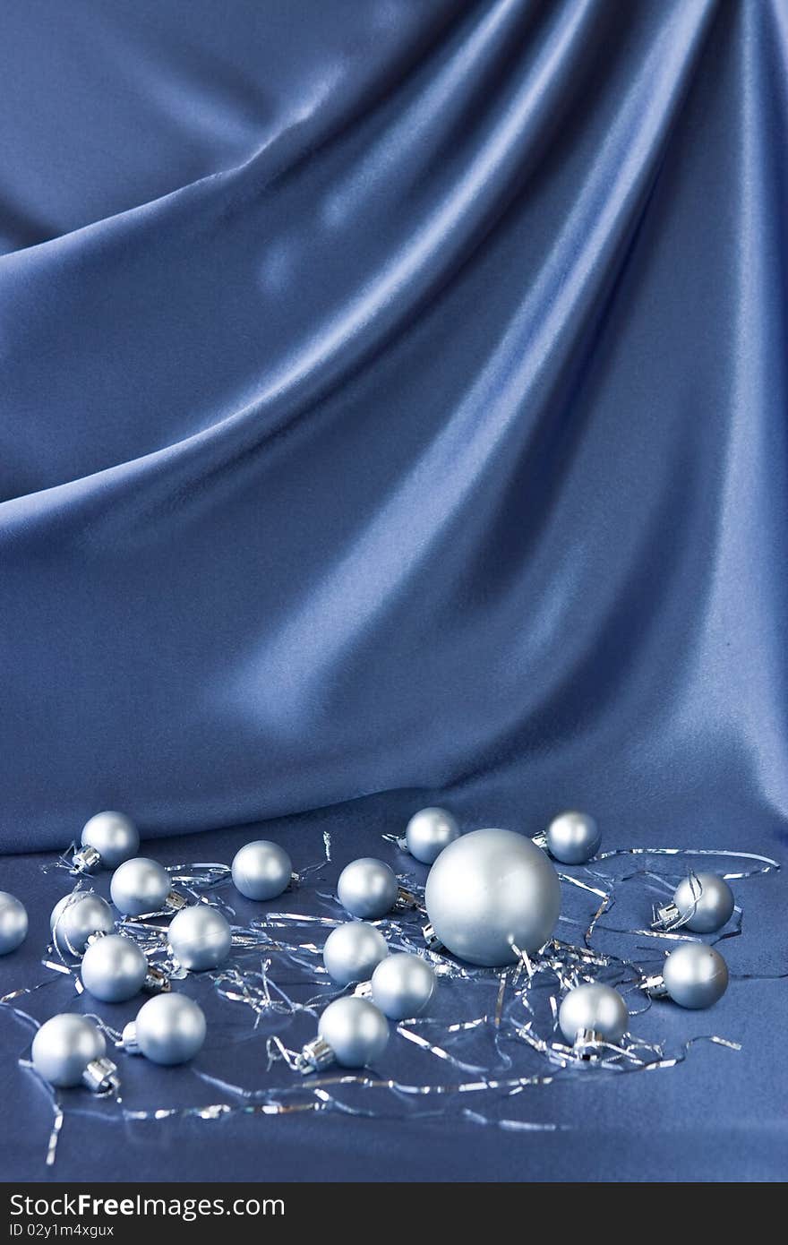 Satin background with Christmas decorations; place for your object. Satin background with Christmas decorations; place for your object