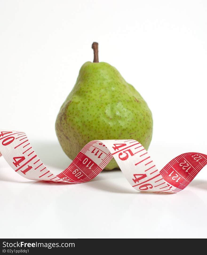 A pear and a measuring tape. A pear and a measuring tape