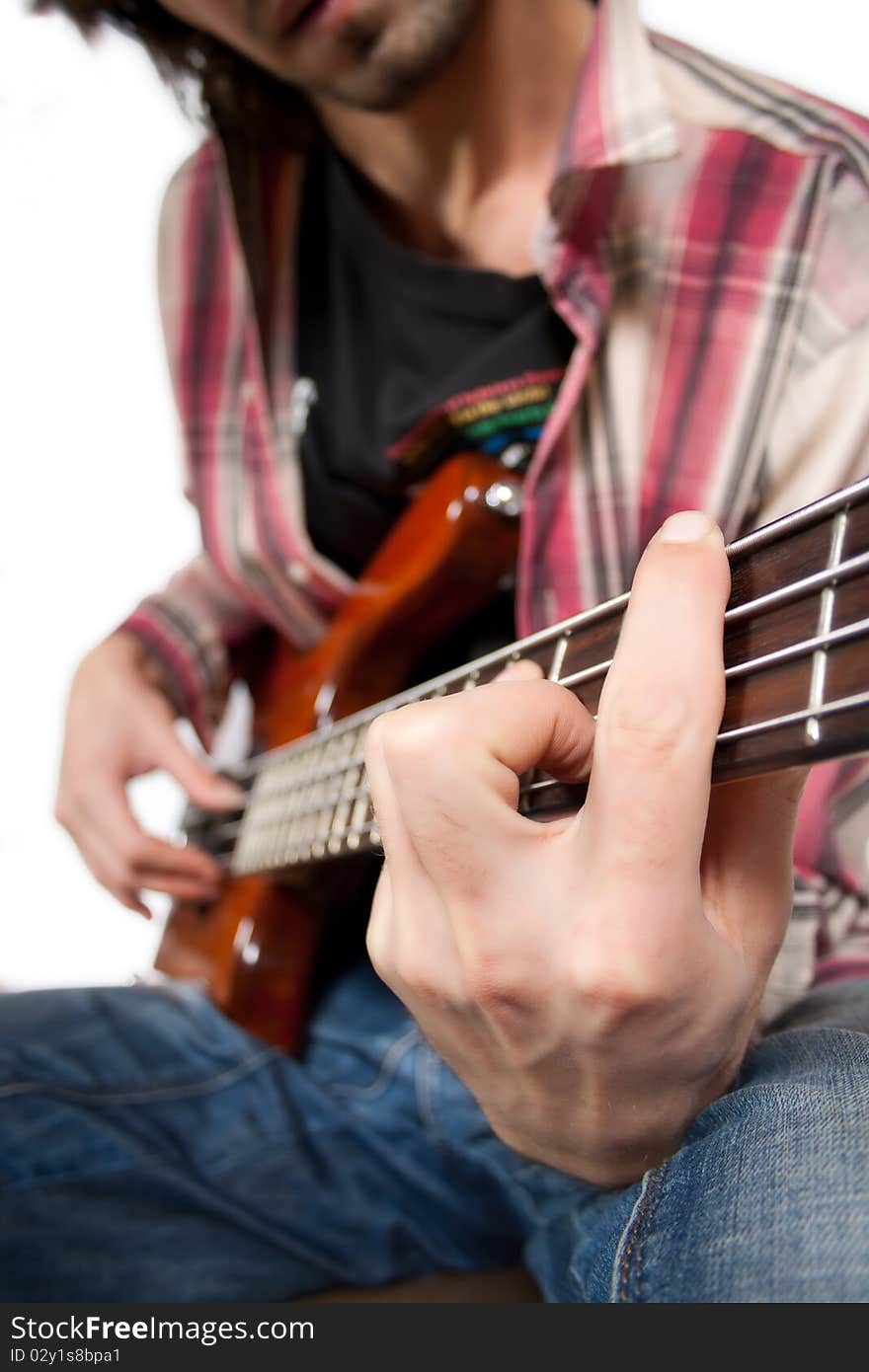 Close-up view of a playing bass guitarist. Close-up view of a playing bass guitarist