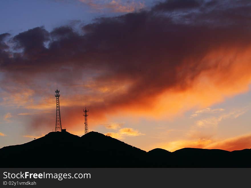 There are many flaming clouds in the sky at sunset