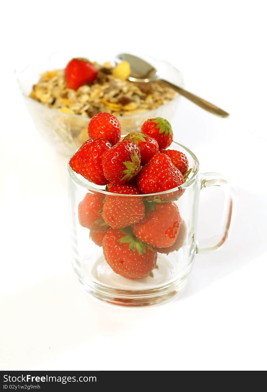 Strawberry In Glass And Muesli Isolated On White