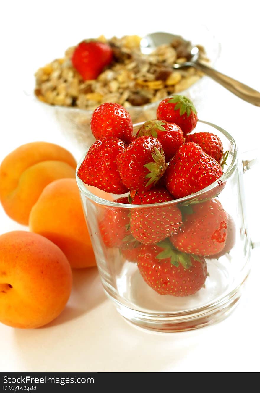 Strawberry in glass and muesli isolated on white background