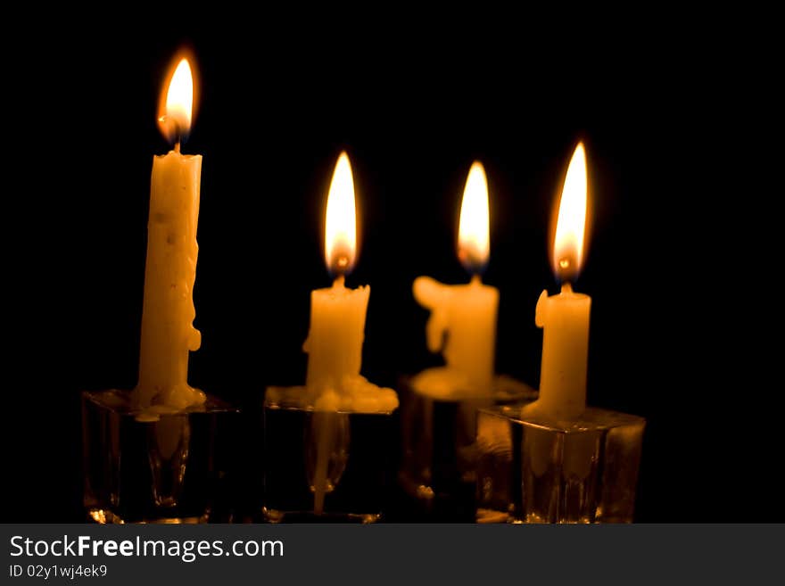 Two Christmas Candles. Red candles with bright glowing flames on a black background. Two Christmas Candles. Red candles with bright glowing flames on a black background.