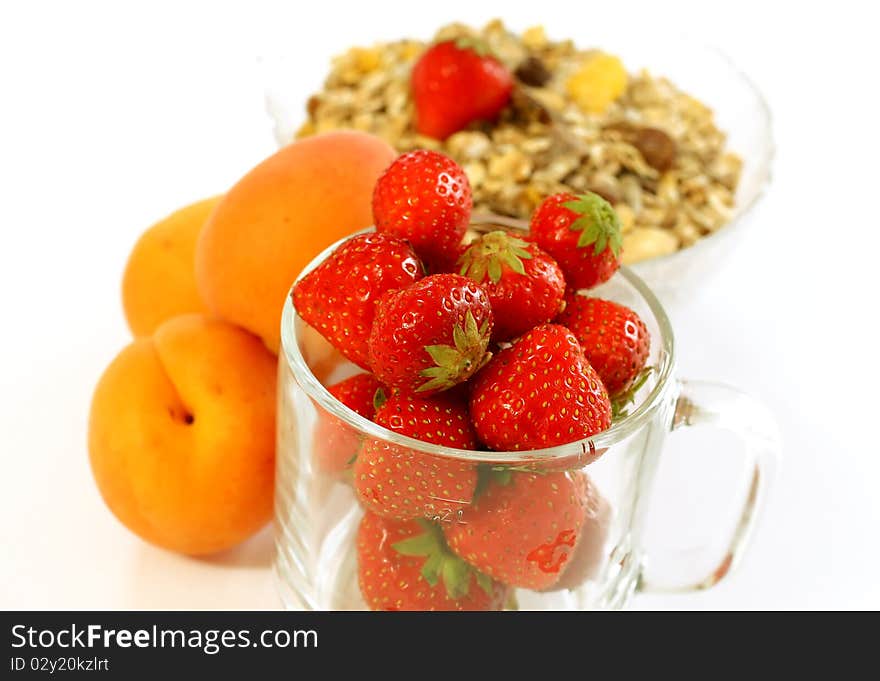 Strawberry in glass and muesli isolated on white