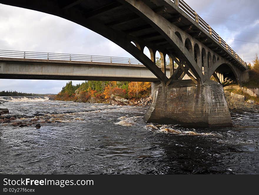 Dramatic wide angel view of bridges spanning a set of rapids in back country of Newfoundland. Dramatic wide angel view of bridges spanning a set of rapids in back country of Newfoundland.