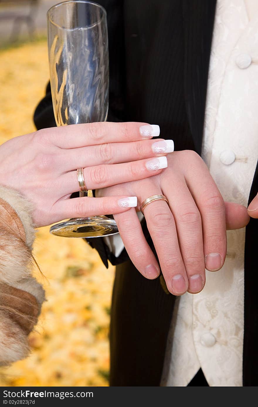 Hands of bride and groom with empty champagne glass. Hands of bride and groom with empty champagne glass