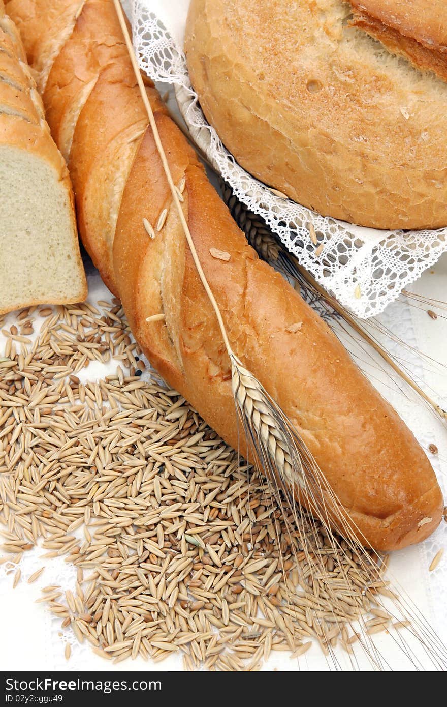 Different bread products with ears of wheat and seeds