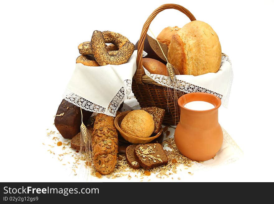 Still-life with  different bread products and jug of milk on white background. Still-life with  different bread products and jug of milk on white background.