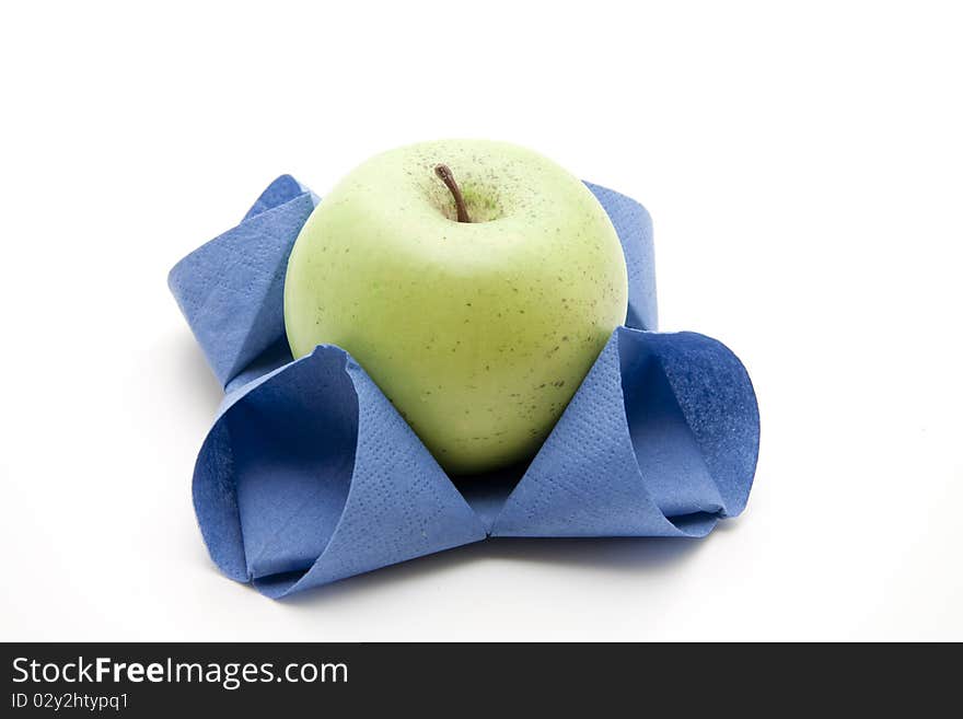 Apple in bluer folded napkin. Apple in bluer folded napkin