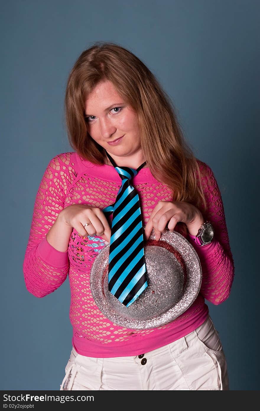 Smiling girl with hat on blue background