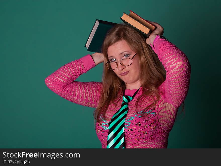 Cute young girl with books in studio