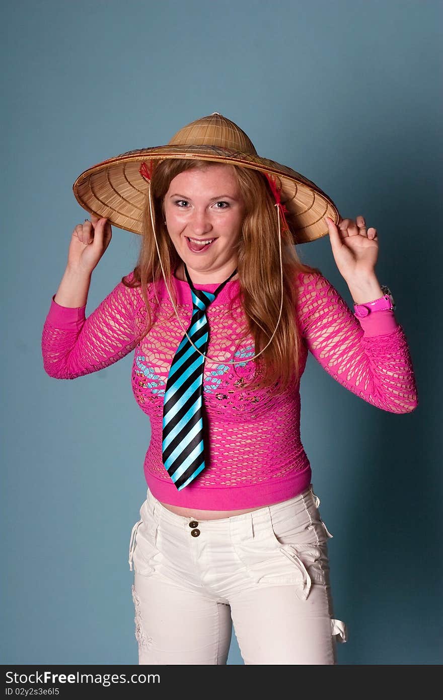 Smiling girl with hat on blue background