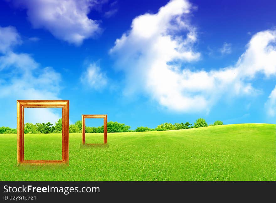 Blank Picture Frame Against Blue Sky And Green Grass