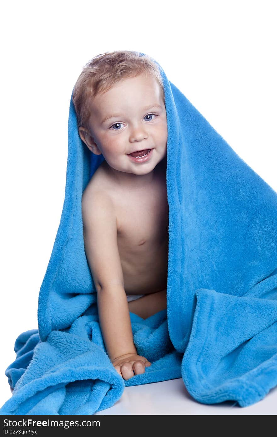 Beautiful baby under a brown towel