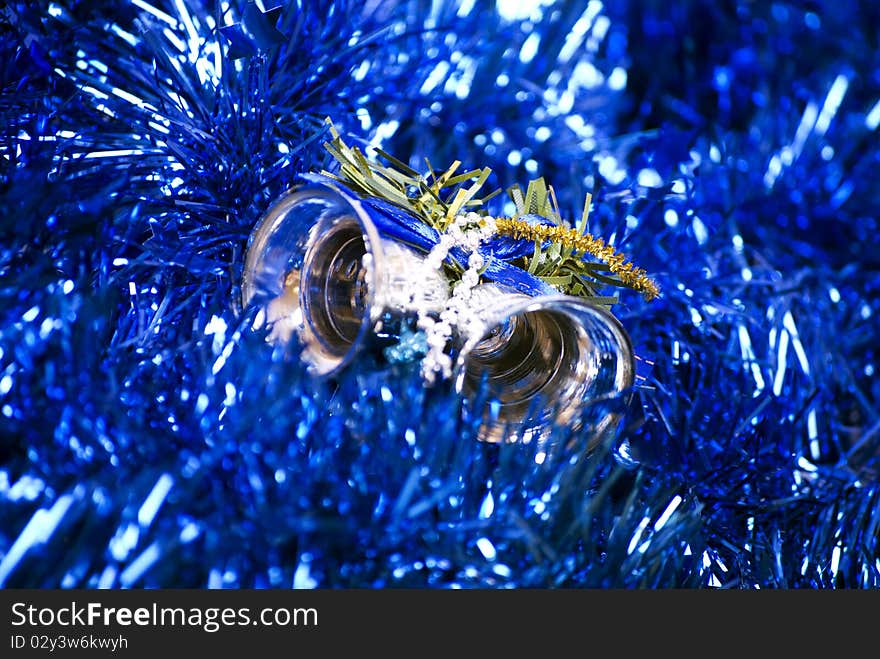 Blue glittering Christmas tinsel and silver bells. Blue glittering Christmas tinsel and silver bells